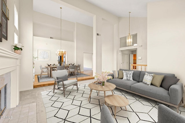 2101 Fox Den Ct, Oxnard, CA 93036 - living room with high vaulted ceiling, an inviting chandelier, a fireplace, baseboards, and visible vents