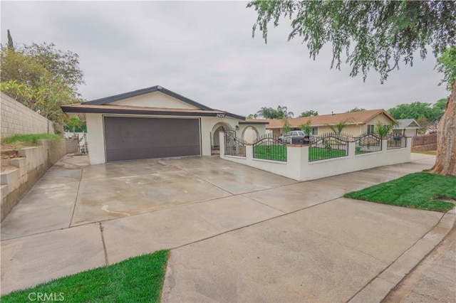 3456 Crownsworth St, Corona, CA 92879 - view of front facade with stucco siding, a fenced front yard, driveway, and an attached garage