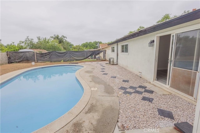 3456 Crownsworth St, Corona, CA 92879 - view of swimming pool with a fenced in pool, cooling unit, and a fenced backyard