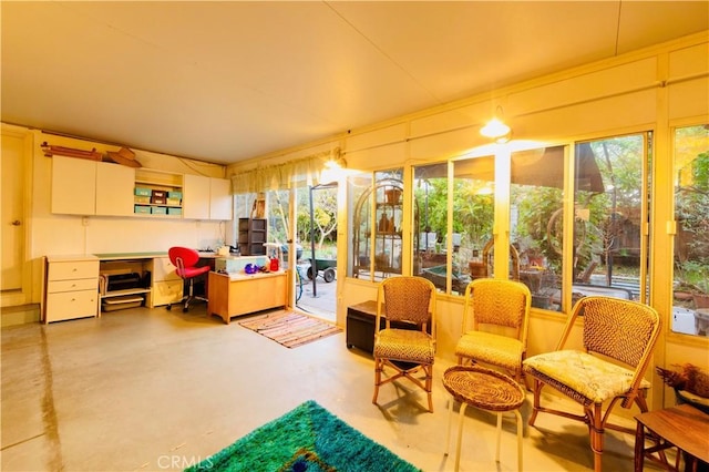 sunroom with concrete flooring and a healthy amount of sunlight