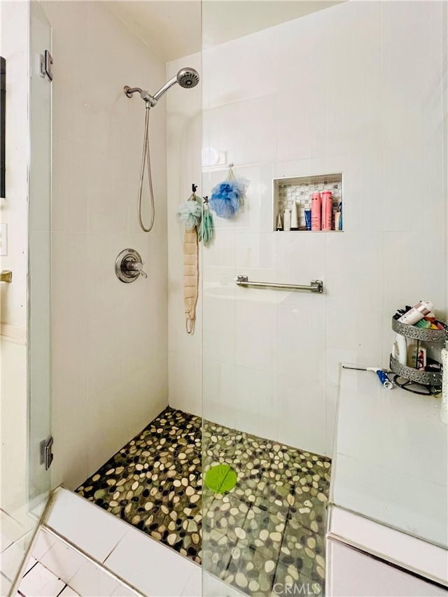full bath featuring a shower stall and tile patterned flooring