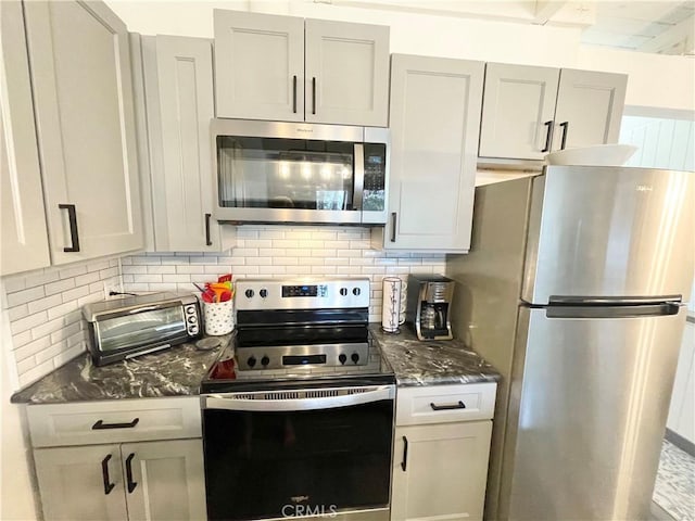 24 Tyrol Ln Unit 103, Mammoth Lakes, CA 95346 - kitchen featuring appliances with stainless steel finishes, backsplash, and dark stone counters