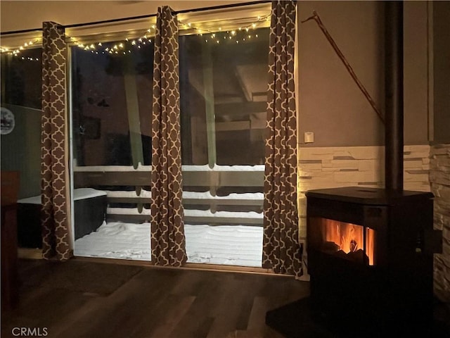 24 Tyrol Ln Unit 103, Mammoth Lakes, CA 95346 - entryway with wood finished floors and a wood stove