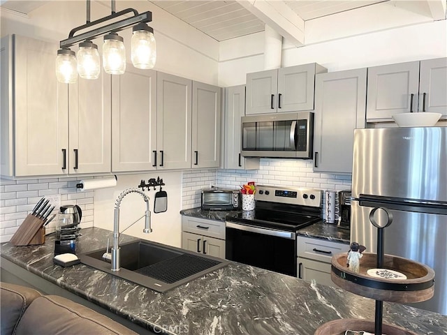 24 Tyrol Ln Unit 103, Mammoth Lakes, CA 95346 - kitchen with stainless steel appliances, decorative backsplash, dark stone counters, and a wood ceiling with exposed beams