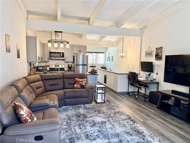 24 Tyrol Ln Unit 103, Mammoth Lakes, CA 95346 - living room featuring wood finished floors, beamed ceiling, and an office area