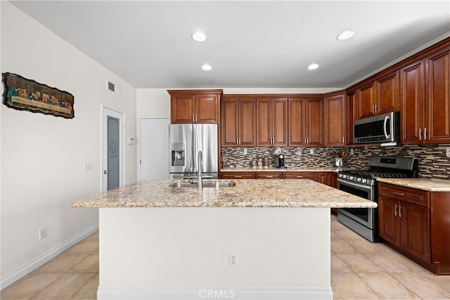 8481 Attica Dr, Riverside, CA 92508 - kitchen with stainless steel appliances, backsplash, a sink, light tile patterned flooring, and a kitchen island with sink