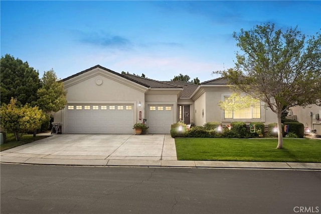 single story home featuring a tile roof, concrete driveway, a front lawn, an attached garage, and stucco siding