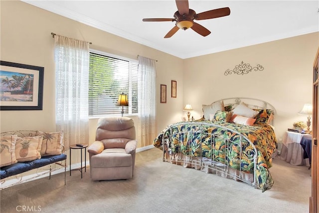 bedroom with crown molding, carpet flooring, baseboards, and a ceiling fan