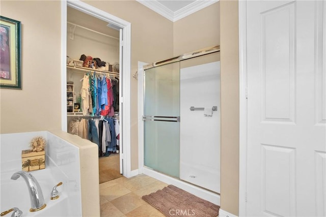 full bath featuring a shower stall, a garden tub, crown molding, tile patterned floors, and a walk in closet