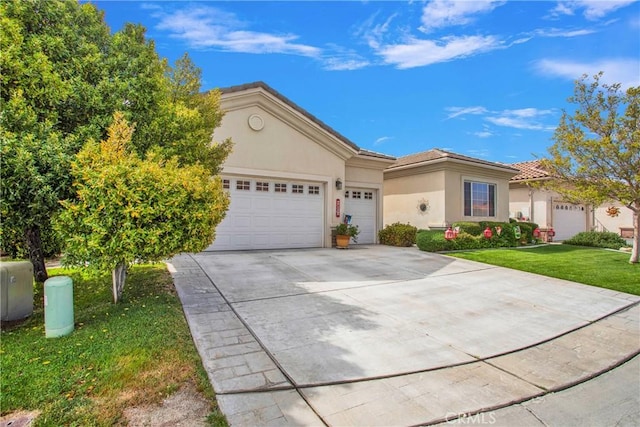 view of front of home featuring a garage, driveway, a tiled roof, a front yard, and stucco siding