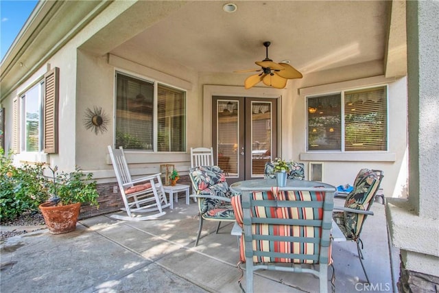 view of patio with french doors, outdoor dining space, and ceiling fan