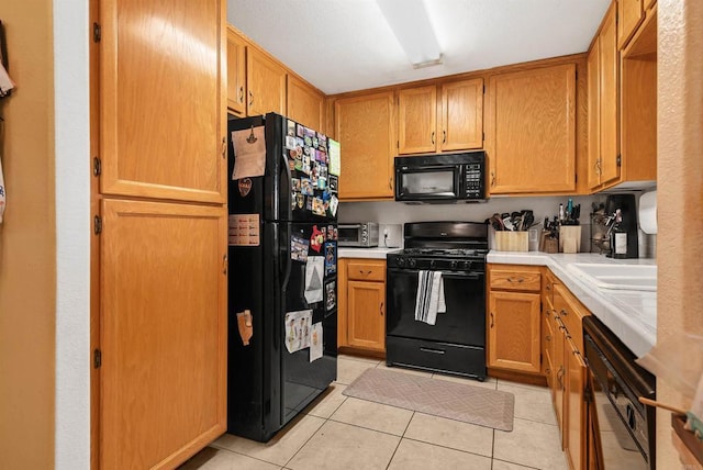 585 Lands End Way Unit 234, Oceanside, CA 92058 - kitchen with black appliances, tile countertops, and light tile patterned floors