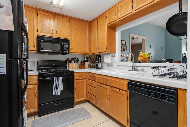 585 Lands End Way Unit 234, Oceanside, CA 92058 - kitchen with black appliances, light tile patterned floors, and a peninsula
