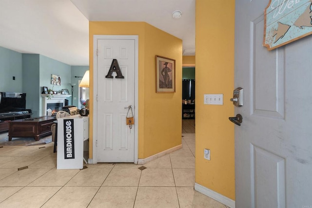 585 Lands End Way Unit 234, Oceanside, CA 92058 - foyer entrance with light tile patterned flooring and a lit fireplace