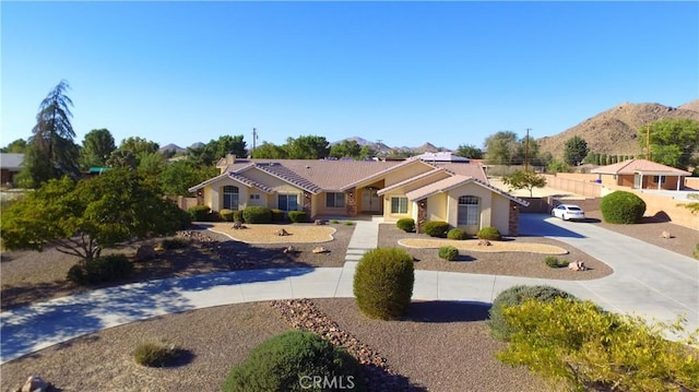 19640 Yanan Rd, Apple Valley, CA 92307 - single story home with a tile roof, curved driveway, stucco siding, and a mountain view