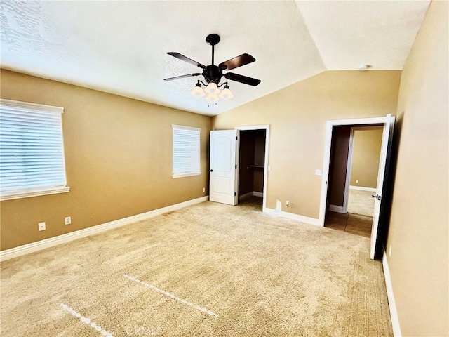 19640 Yanan Rd, Apple Valley, CA 92307 - unfurnished bedroom with carpet flooring, multiple windows, vaulted ceiling, and baseboards