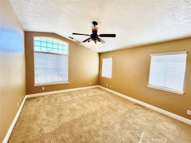 19640 Yanan Rd, Apple Valley, CA 92307 - carpeted empty room with a ceiling fan, lofted ceiling, a textured ceiling, baseboards, and visible vents