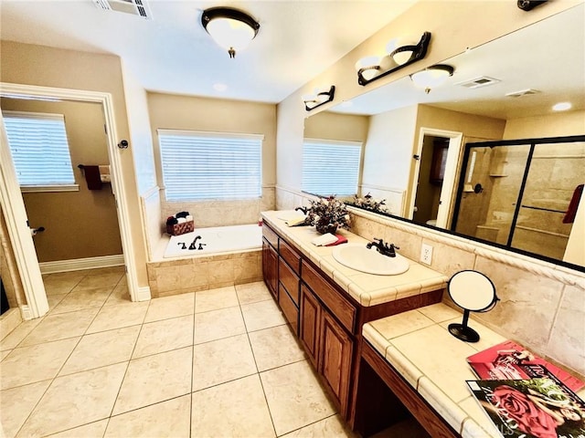 19640 Yanan Rd, Apple Valley, CA 92307 - bathroom featuring a shower stall, a healthy amount of sunlight, tile patterned floors, and a garden tub