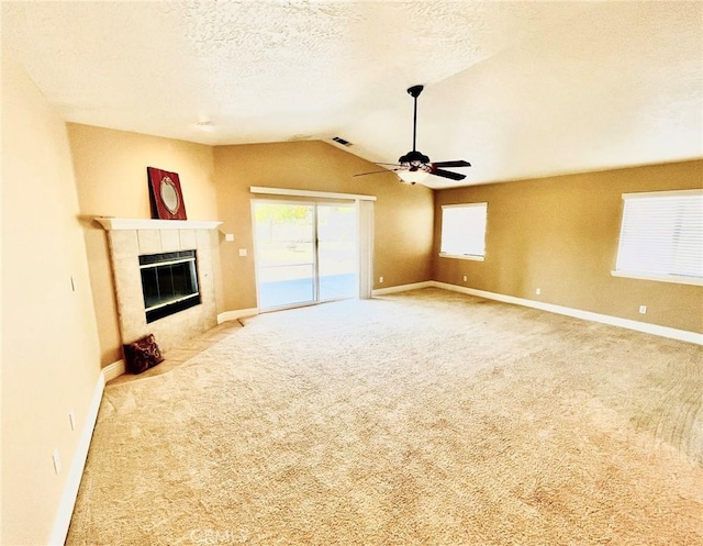 19640 Yanan Rd, Apple Valley, CA 92307 - unfurnished living room featuring lofted ceiling, visible vents, carpet flooring, a ceiling fan, and a tile fireplace