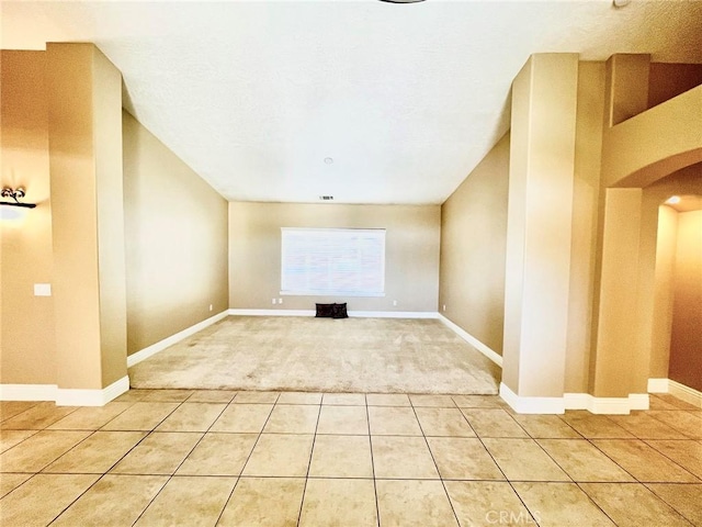 19640 Yanan Rd, Apple Valley, CA 92307 - interior space featuring light carpet, arched walkways, baseboards, and light tile patterned floors