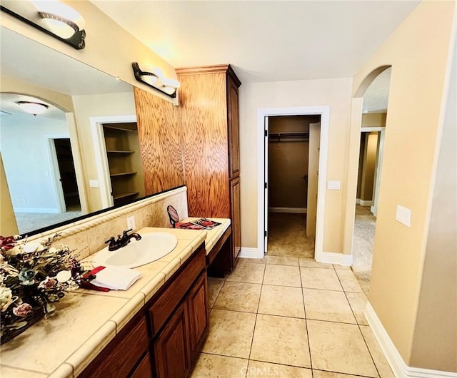 19640 Yanan Rd, Apple Valley, CA 92307 - bathroom featuring tile patterned floors, baseboards, vanity, and a spacious closet