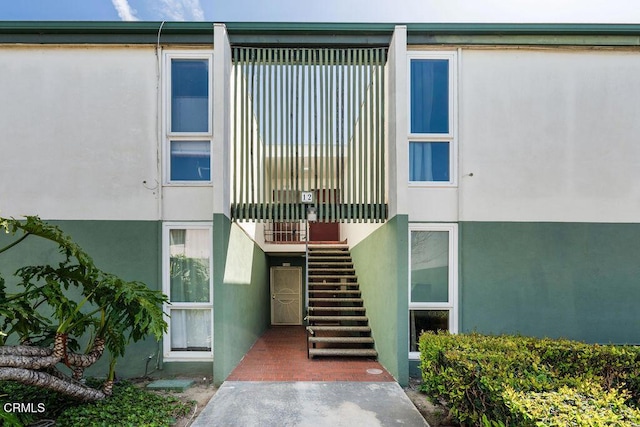 entrance to property with stucco siding