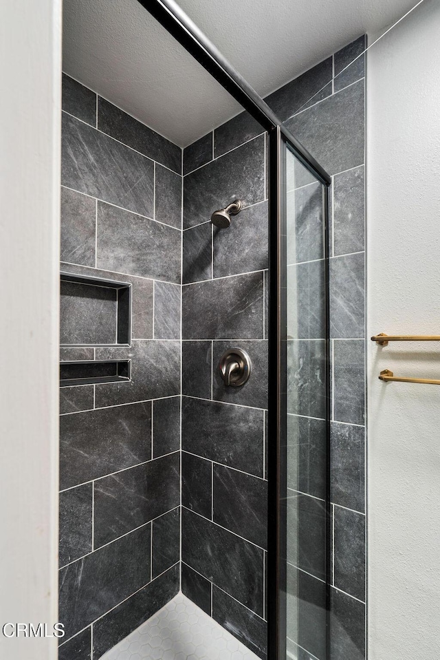 bathroom featuring a shower stall