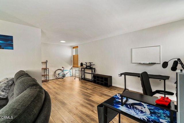 interior space with baseboards and wood finished floors