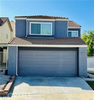 14679 Cinnamon Dr, Fontana, CA 92337 - view of front of property featuring concrete driveway, a tile roof, and stucco siding