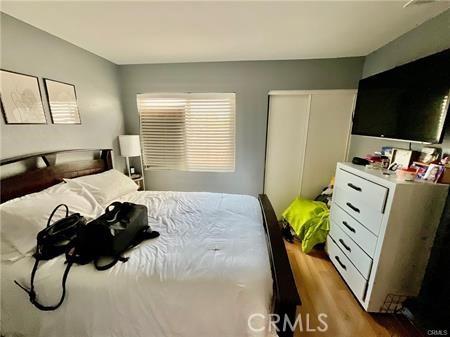 14679 Cinnamon Dr, Fontana, CA 92337 - bedroom with a closet and wood finished floors