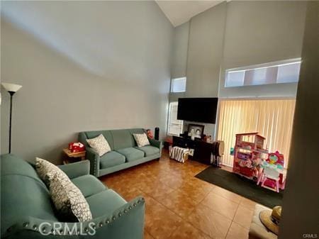 14679 Cinnamon Dr, Fontana, CA 92337 - tiled living room with high vaulted ceiling