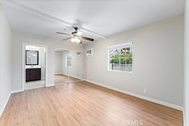 unfurnished bedroom with a ceiling fan, connected bathroom, light wood-type flooring, a closet, and baseboards