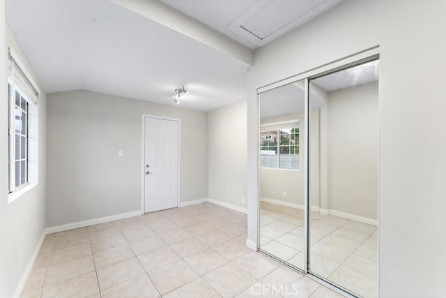 foyer featuring baseboards and light tile patterned floors
