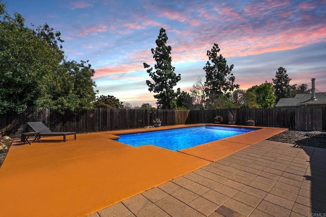 view of swimming pool featuring a fenced in pool, a patio area, and a fenced backyard