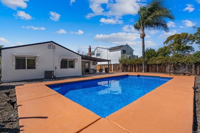 view of pool with central AC, a fenced backyard, a fenced in pool, and a patio