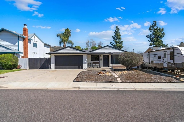 single story home featuring a garage, fence, and concrete driveway
