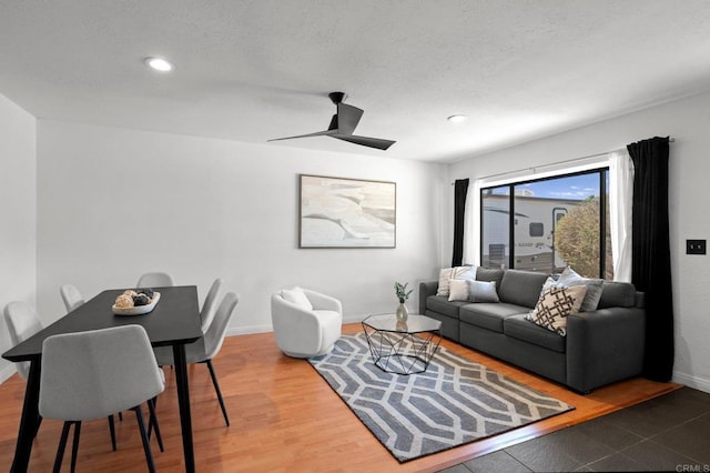 living area with recessed lighting and baseboards