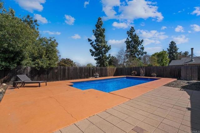 view of pool with a fenced in pool, a patio, and a fenced backyard