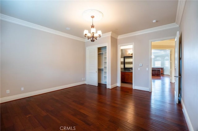 interior space with baseboards, dark wood-style floors, an inviting chandelier, and crown molding