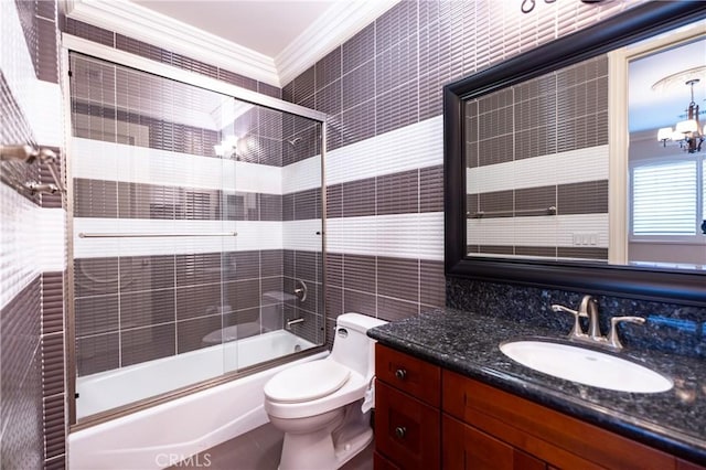 bathroom with shower / bath combination with glass door, toilet, vanity, ornamental molding, and tile walls