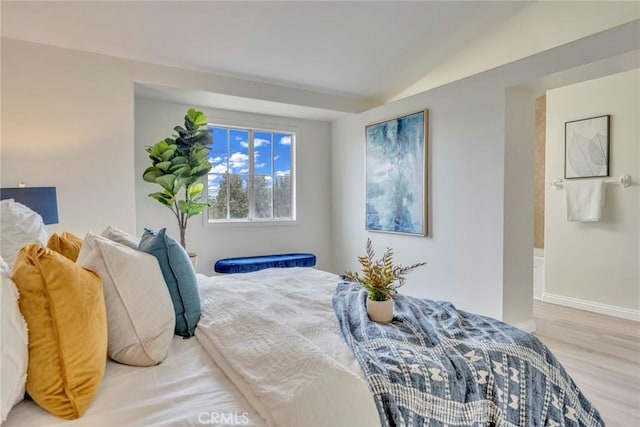 bedroom featuring wood finished floors and baseboards