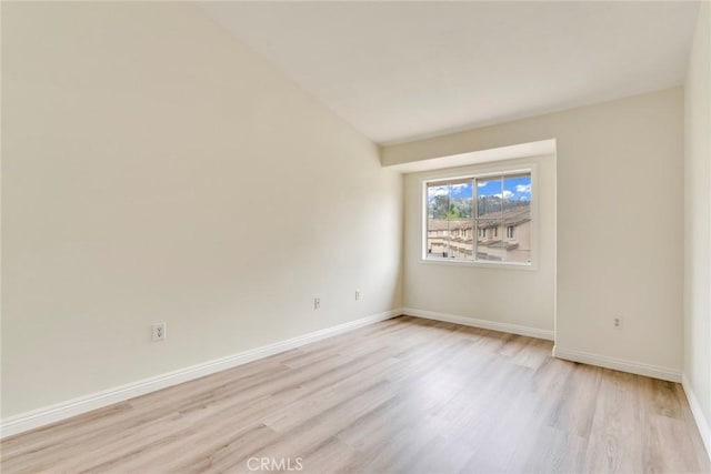 unfurnished room featuring light wood-style floors and baseboards