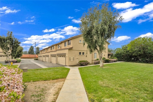 view of side of home with a yard and stucco siding