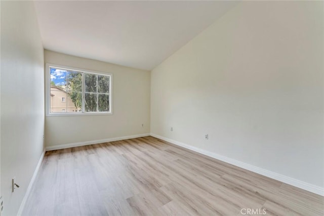 unfurnished room with light wood finished floors and baseboards
