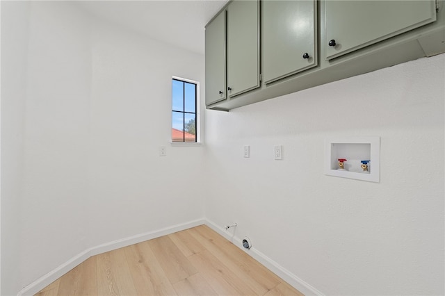 laundry room featuring light wood-type flooring, baseboards, hookup for a gas dryer, hookup for a washing machine, and cabinet space