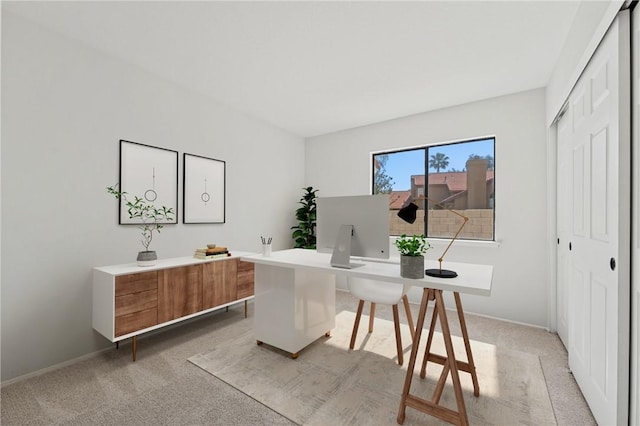 home office featuring light carpet and baseboards
