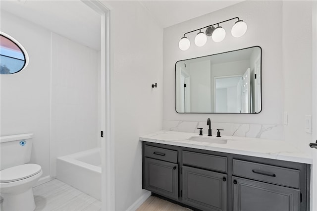 full bathroom featuring vanity, baseboards, and toilet