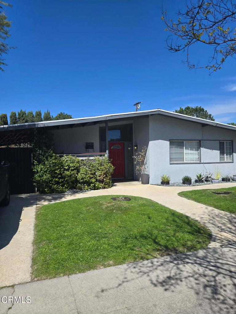 ranch-style home with stucco siding and a front yard