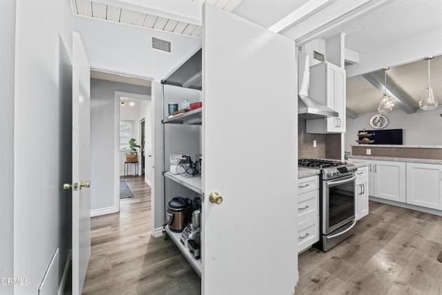 19459 Lull St, Reseda, CA 91335 - kitchen with gas range, wall chimney exhaust hood, white cabinets, backsplash, and light wood finished floors