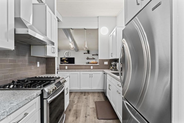 19459 Lull St, Reseda, CA 91335 - kitchen featuring stainless steel appliances, wall chimney exhaust hood, backsplash, white cabinets, and light wood-type flooring